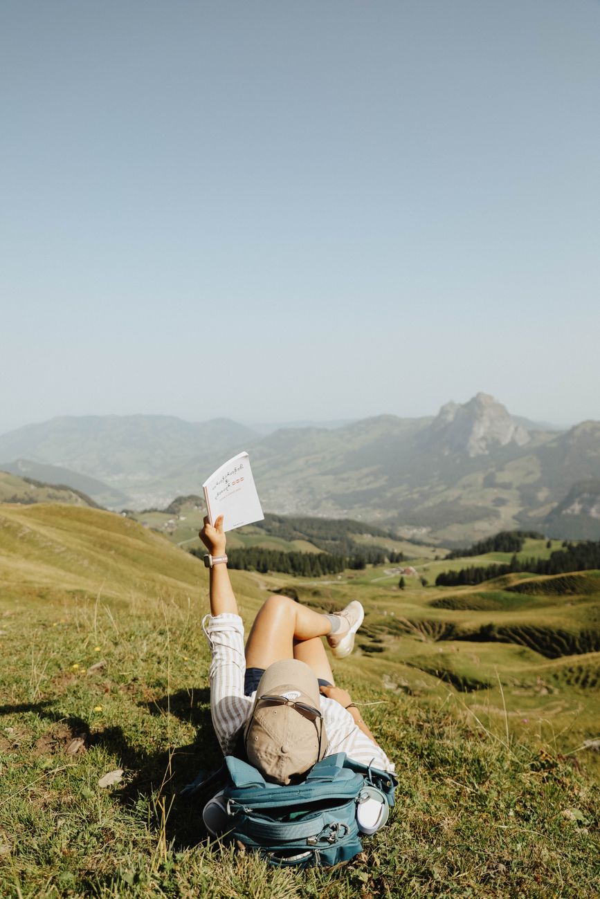 Bespoke travel itinerary notebook with mountain landscape backdrop